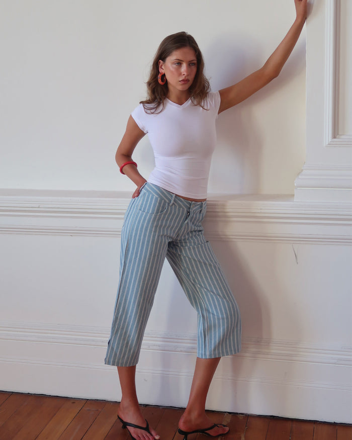 Women's low waisted pant in denim stripe featuring 3/4 length and straight leg fit.
