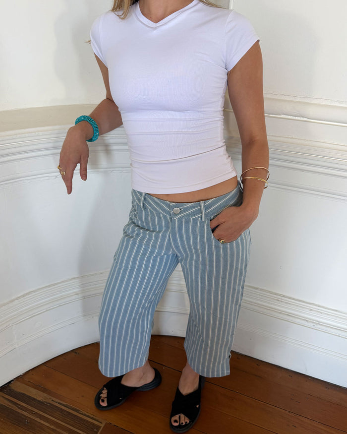 Women's low waisted pant in denim stripe featuring 3/4 length and straight leg fit.