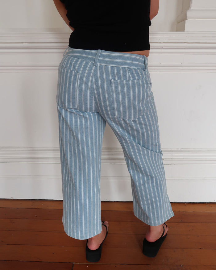 Women's low waisted pant in denim stripe featuring 3/4 length and straight leg fit.