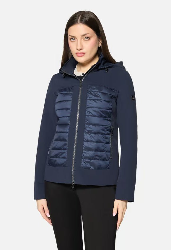 Woman wearing a navy blue hooded jacket on a white background