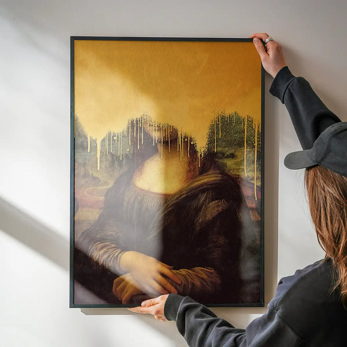 Drippy Mona Lisa Gold Graffiti Print being hung on a wall in a black frame
