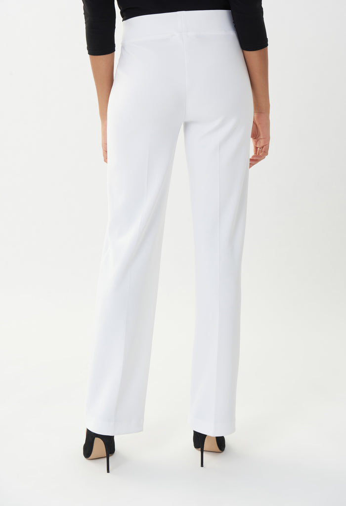 White pants worn by a person on a white background