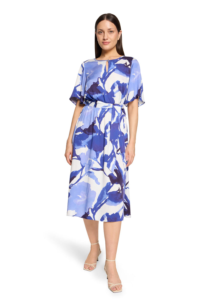 Woman wearing a blue floral dress on a white background