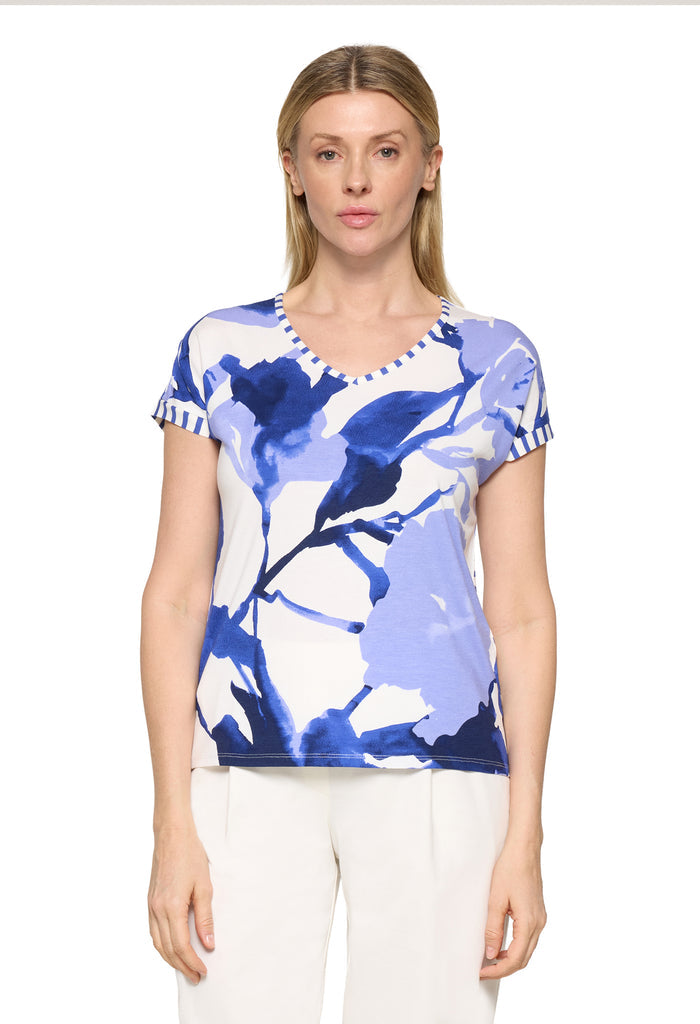 Woman wearing a blue floral patterned shirt on a white background