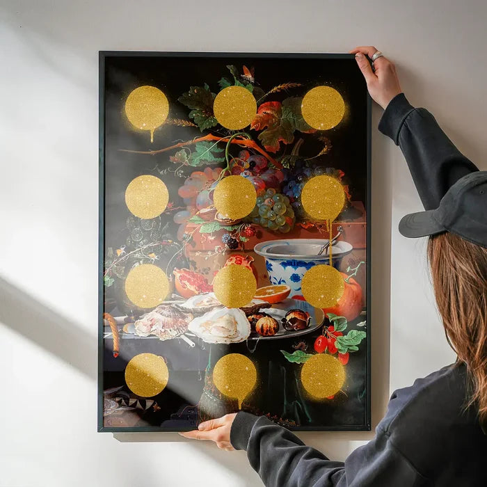 Gold Glitter Dots Still Life Print being hung on a wall in a black frame