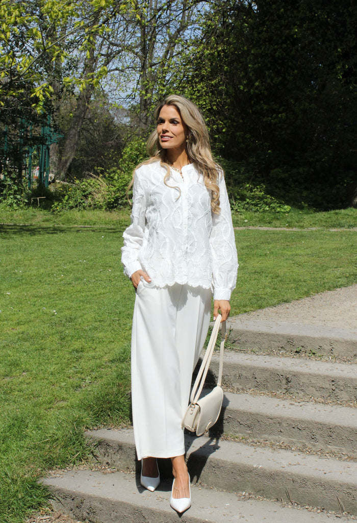 Lace blouse with decorative hem