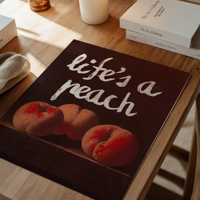 Life's A Peach Altered Art Print, quirky altered art print unframed on a home office desk