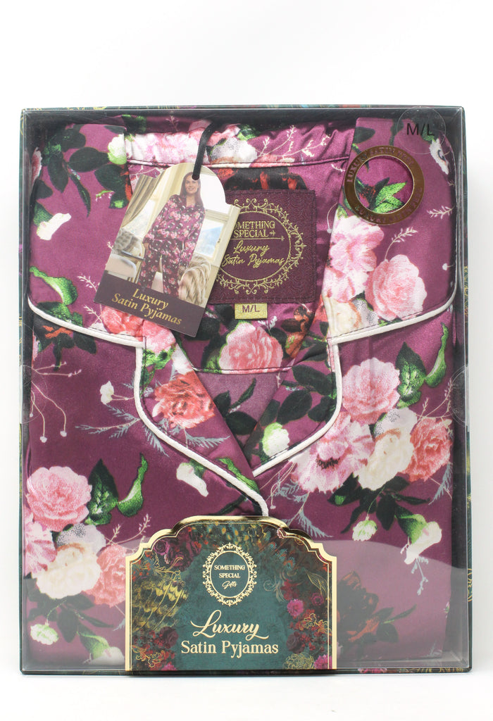 Floral patterned satin pyjamas in packaging with visible brand label.