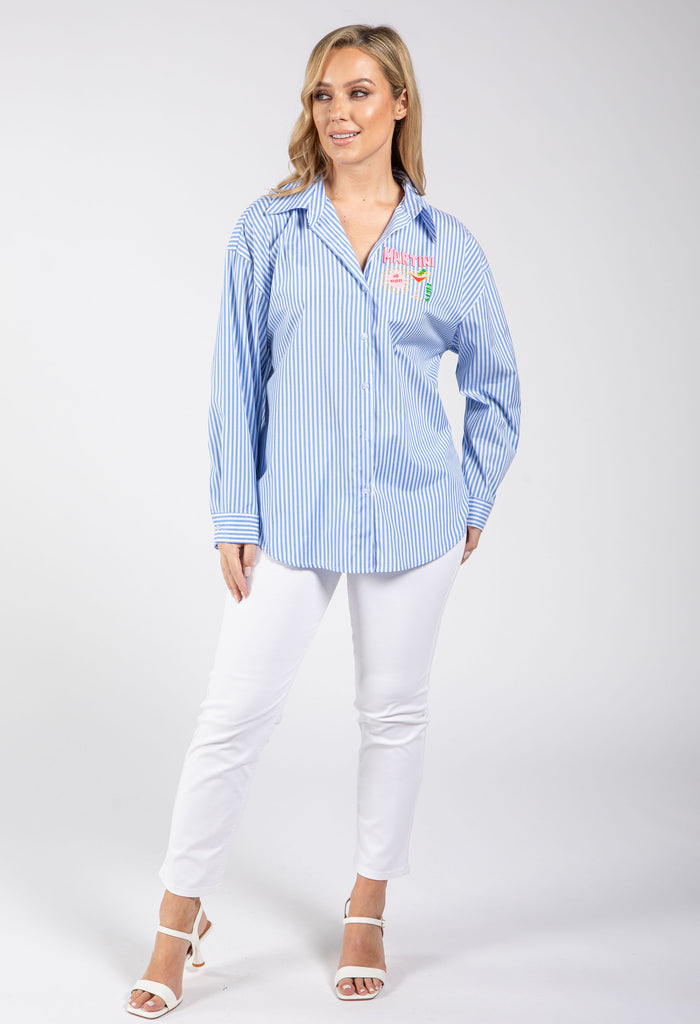 Woman wearing a blue striped shirt with a colorful design on a white background