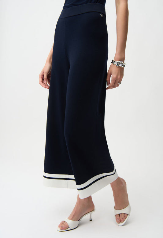 Navy wide-leg pants with white trim worn by a person on a white background