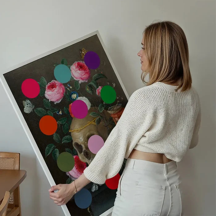 Modern Art Dots Still Life Skull and Flowers Altered Art Print held up against a living room wall