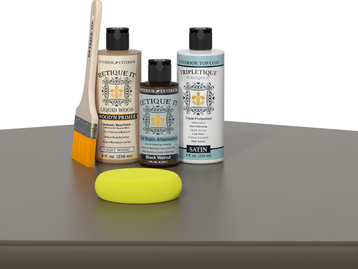Retique It® Black Walnut kit with brush, Wood’n Primer, satin top coat, and yellow sponge on a wood surface.