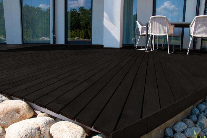 Retique It Wood'n Finish Kit in Classic Black, exterior top coat applied to wooden decking, showing smooth, finished surface.