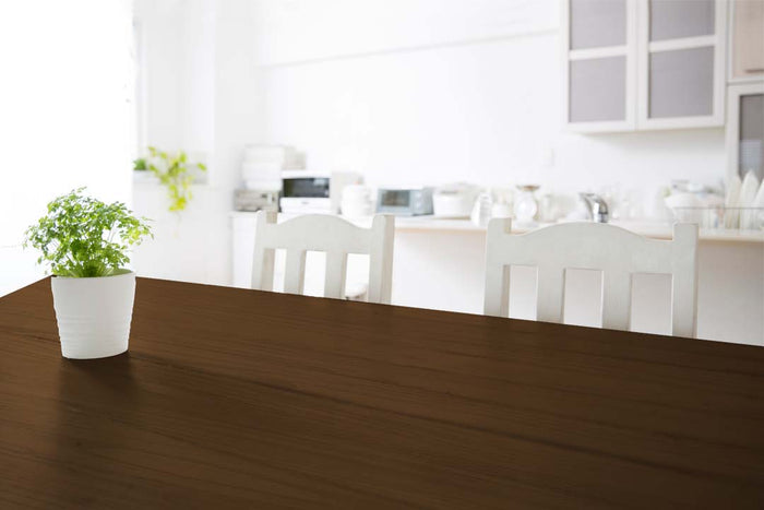 Retique It Wood'n Finish Kit in Vintage Cherry, medium-sized, applying interior top coat on a wooden tabletop.