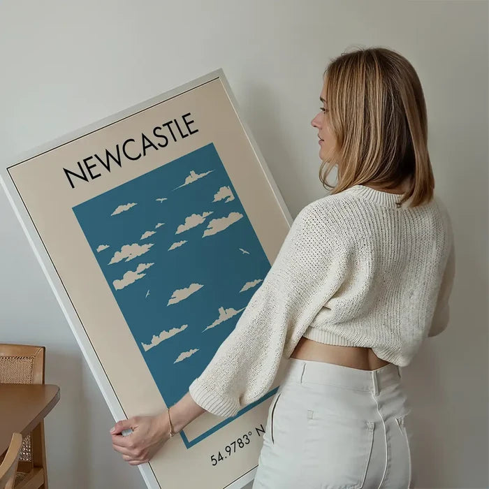 Newcastle Tourist Style Print held up against a living room wall