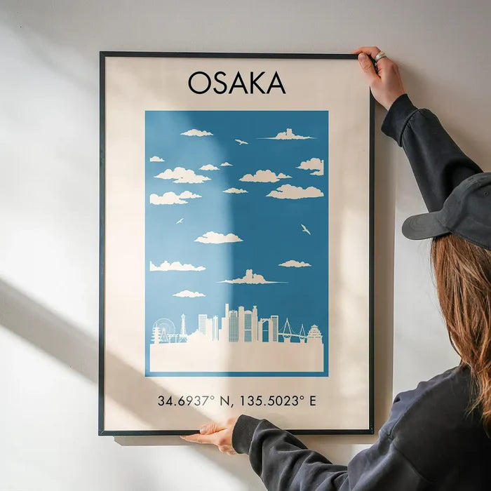 Osaka Tourist Style Print being hung on a wall in a black frame