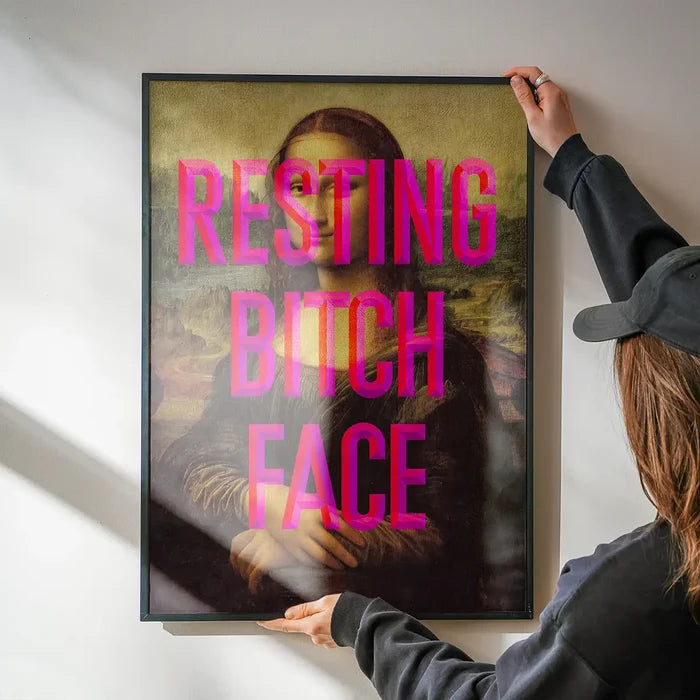 Resting Bitch Face Mona Lisa Print being hung on a wall in a black frame