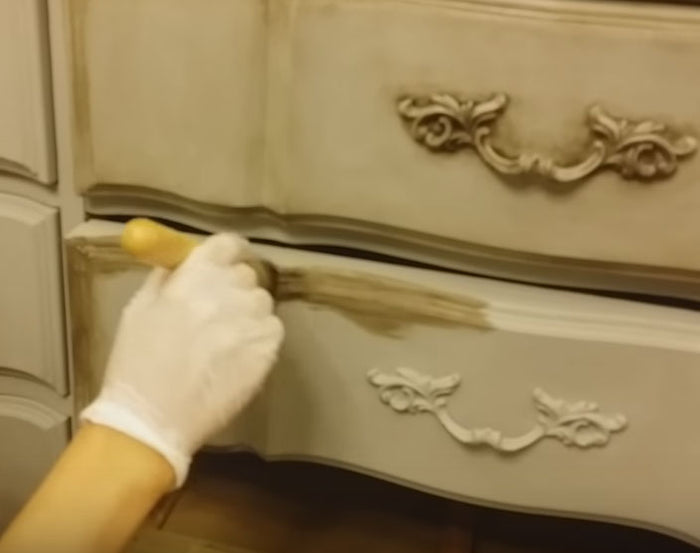Retique It dark furniture wax applied to wood surface, showcasing protective coating and sealant for furniture finishing.