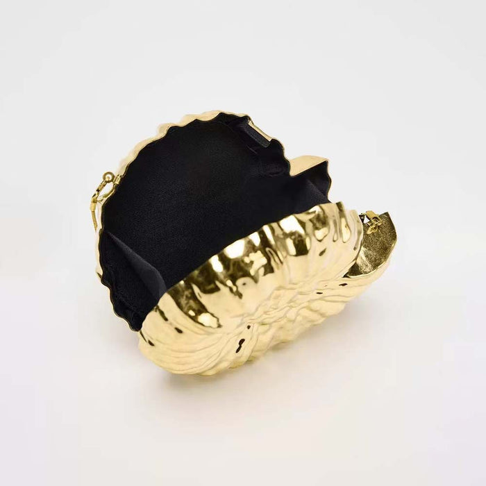 Round sculpted gold clutch with organic texture – BLOOM