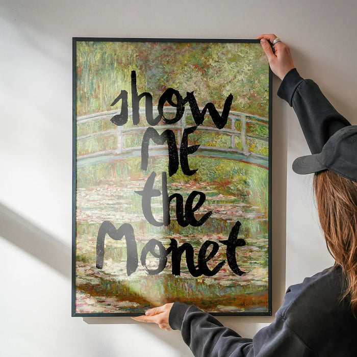 Show Me The Monet Altered Art Print being hung on a wall in a black frame