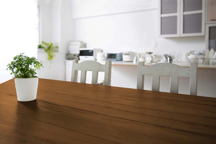 Retique It Wood'n Finish Kit with four vintage cherry stain bottles and a grained tabletop surface for wood finishing.