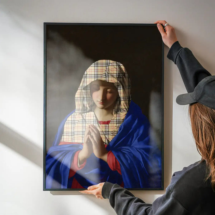 Virgin Mary Fashion Hood Print being hung on a wall in a black frame