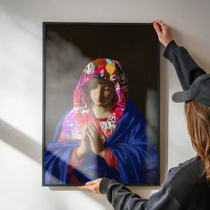 Virgin Mary Graffiti Hood Print being hung on a wall in a black frame