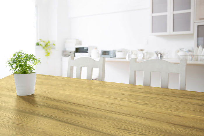 Retique It Weathered Finish Kit in Canary Yellow applied on a wooden tabletop, showcasing a distressed, weathered wood finish.
