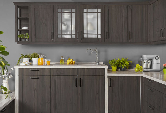 Retique It weathered finish kit in charcoal applied to kitchen cabinets, showcasing a rustic, aged wood appearance.