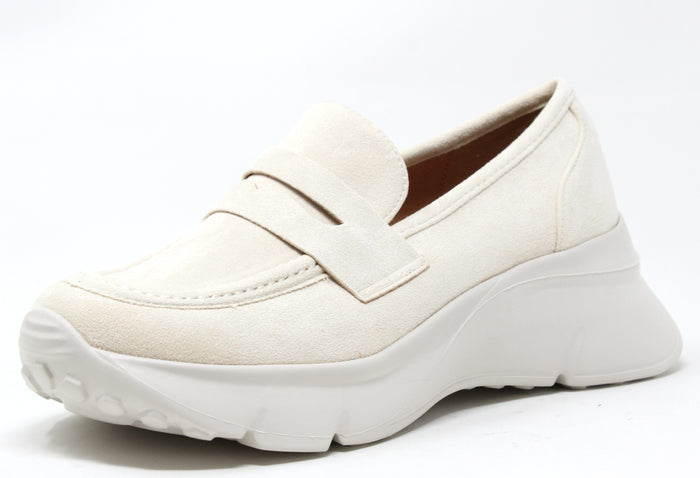 A beige faux suede wedge penny loafer with a round toe and chunky sole.