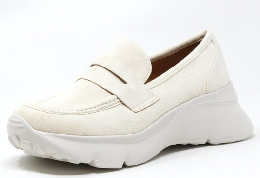 A beige faux suede wedge penny loafer with a round toe and chunky sole.
