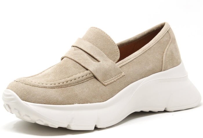 A beige faux suede wedge penny loafer with a round toe and chunky sole.