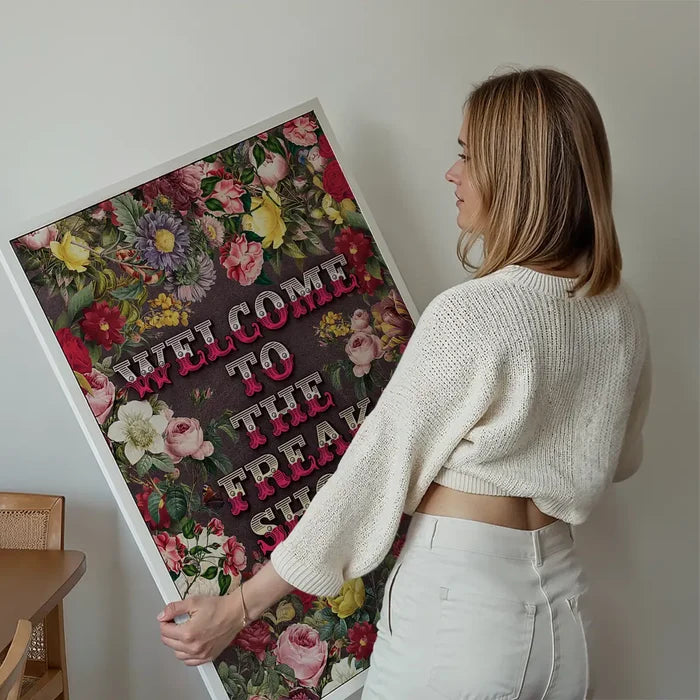 Welcome to the Freakshow Typography Maximalist Print held up against a living room wall