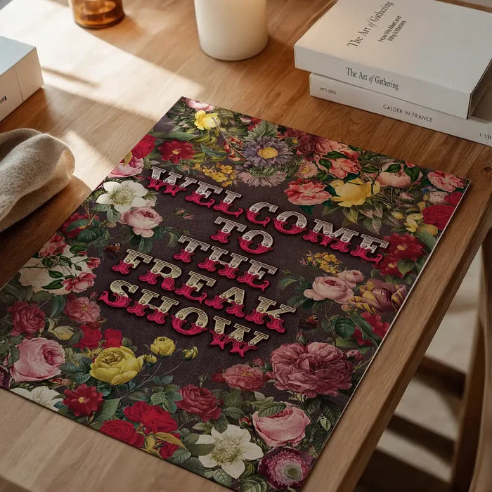 Welcome to the Freakshow Typography Maximalist Print, floral art print unframed on a home office desk