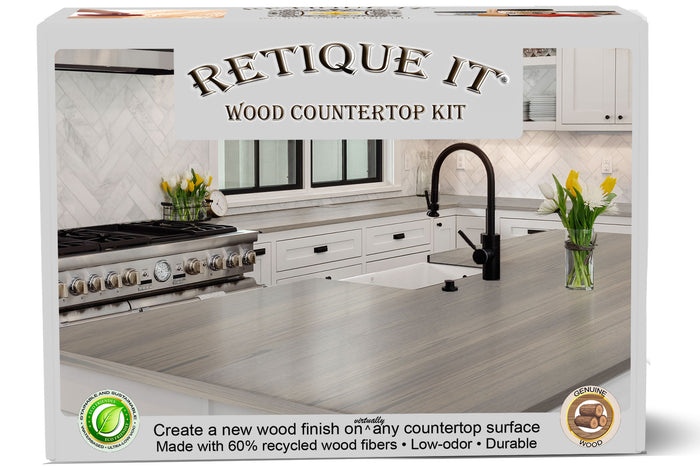 Retique It Wood'n Finish countertop kit with wood veneer sheets and finishing tools laid out on a work surface.
